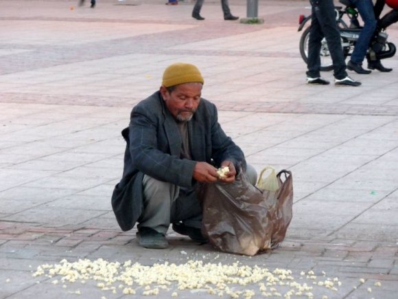 Marakeş - Sokak hayvanları için olduğunu düşündüğümüz ekmek doğrayan adam.